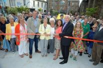 The mayor of Hayle Nick Farrar and president of the Hayle Branch of the RNLI Pauline Marks (centre) watched by members of the community cut the ribbon to officially re-open the Isis gardens in Foundry Square in Hayle